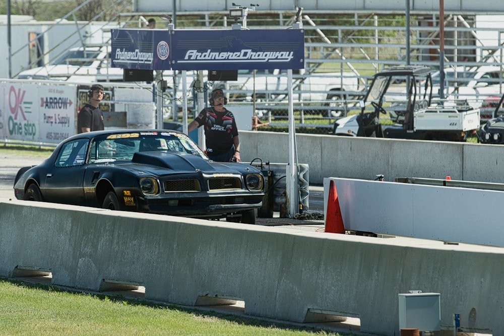 a car being worked on at a drag track
