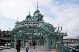 a couple of people that are standing in front of a clock