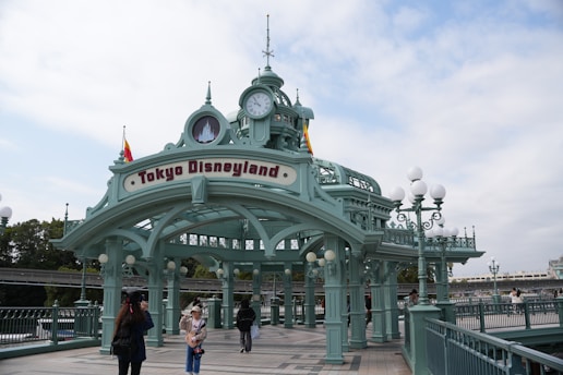a couple of people that are standing in front of a clock