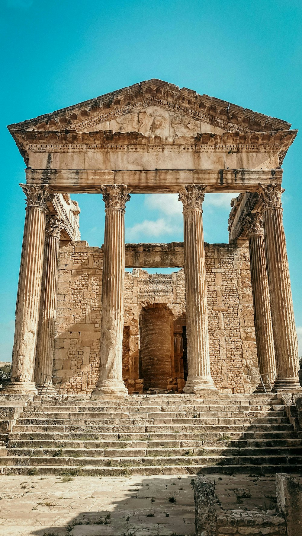 a stone building with columns and steps leading up to it