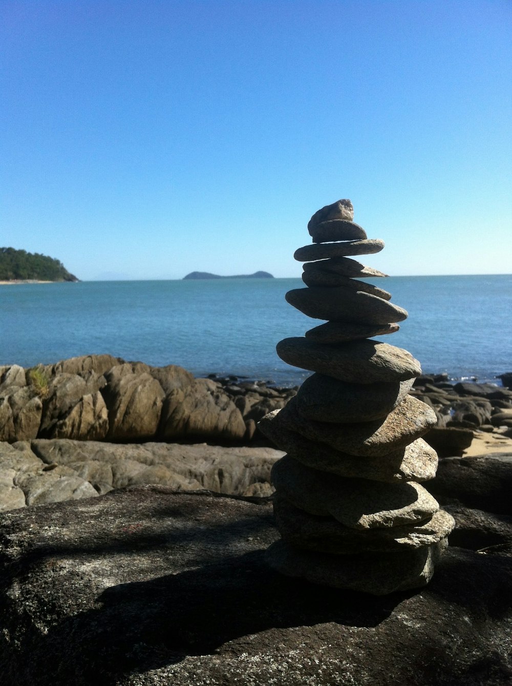 a stack of rocks sitting on top of a rocky beach