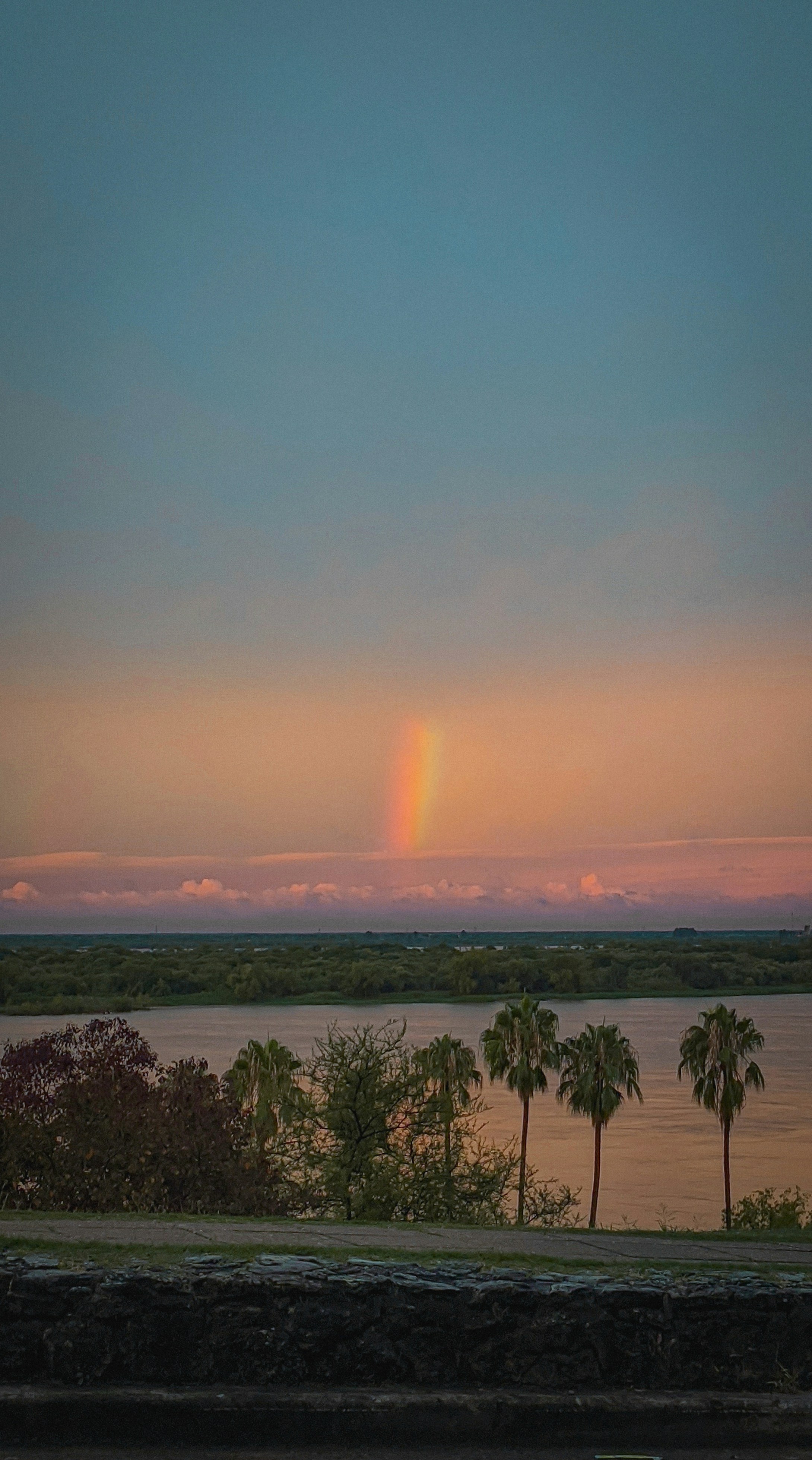 the sun is setting over a body of water