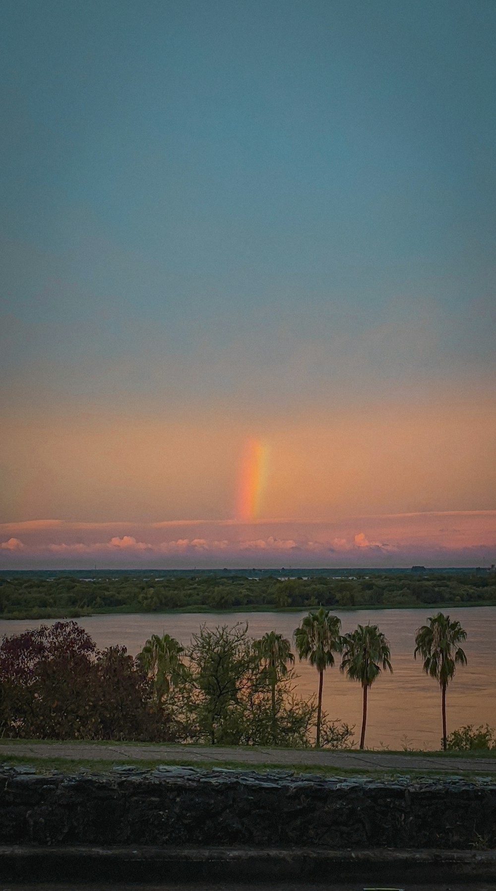 the sun is setting over a body of water