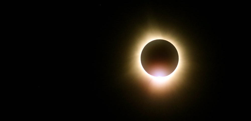 a solar eclipse is seen in the dark sky