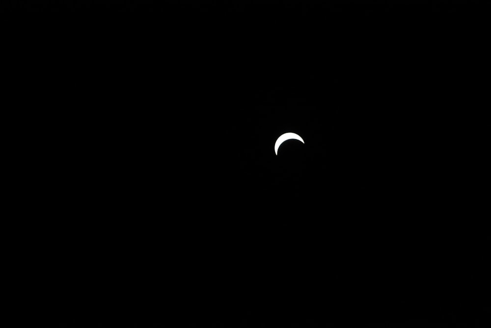 the moon is seen in the dark sky