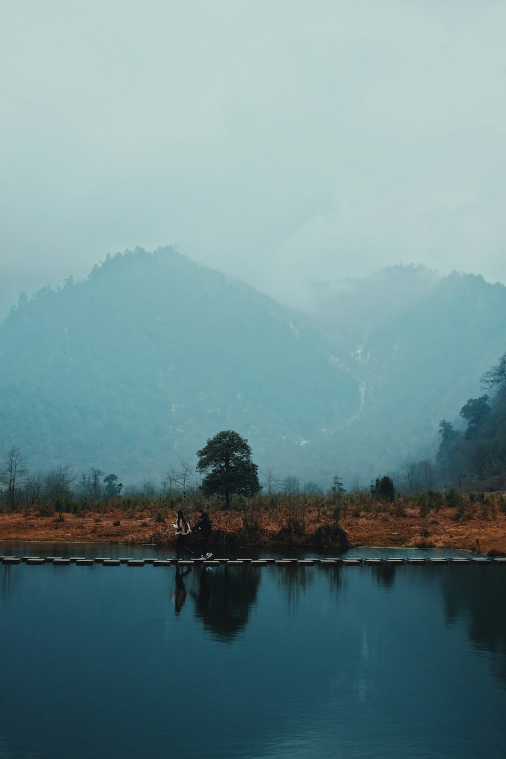 two people are sitting on a boat in the water