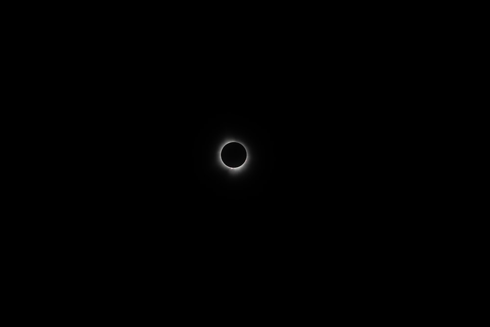 a solar eclipse is seen in the dark sky