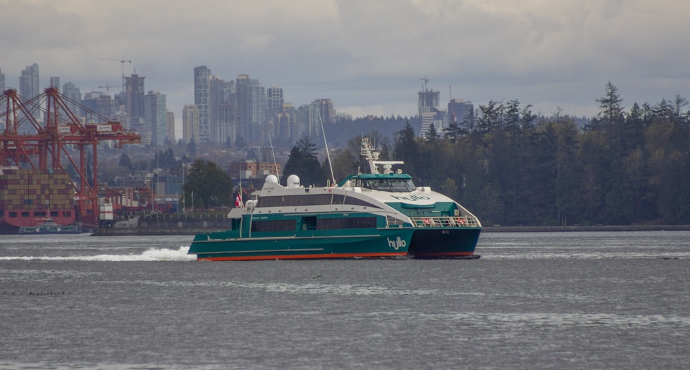 a green and white boat in a body of water