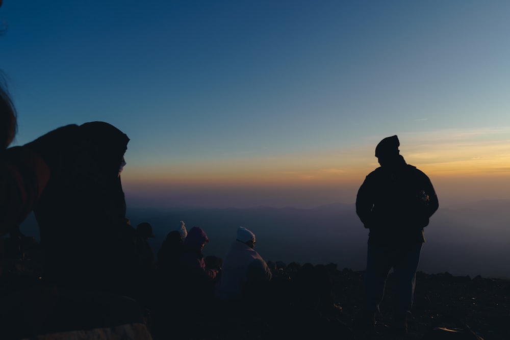 un groupe de personnes debout au sommet d’une montagne