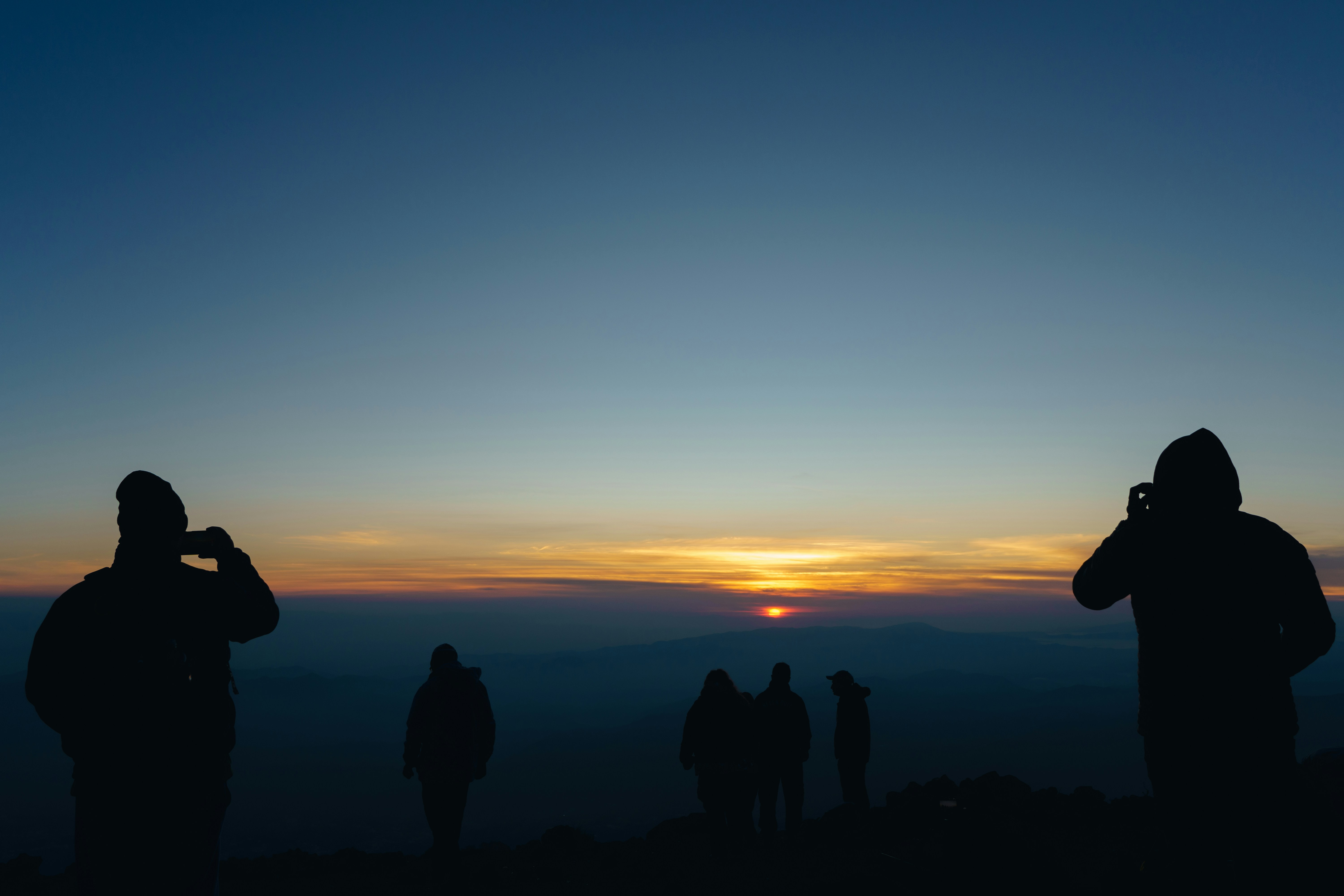 a group of people standing on top of a mountain