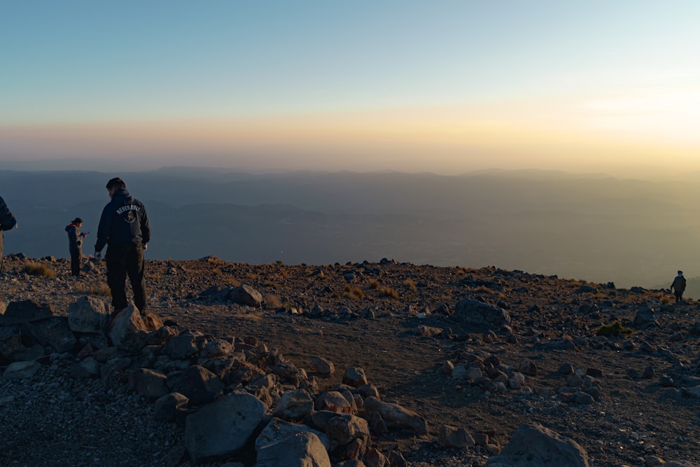 a group of people standing on top of a mountain