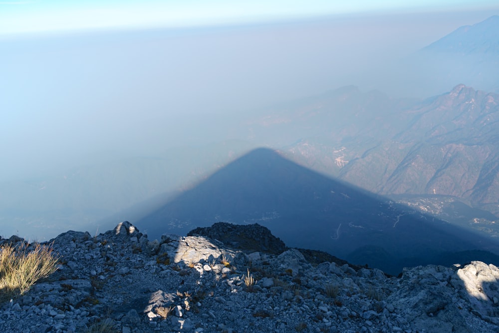 a shadow of a person on a mountain