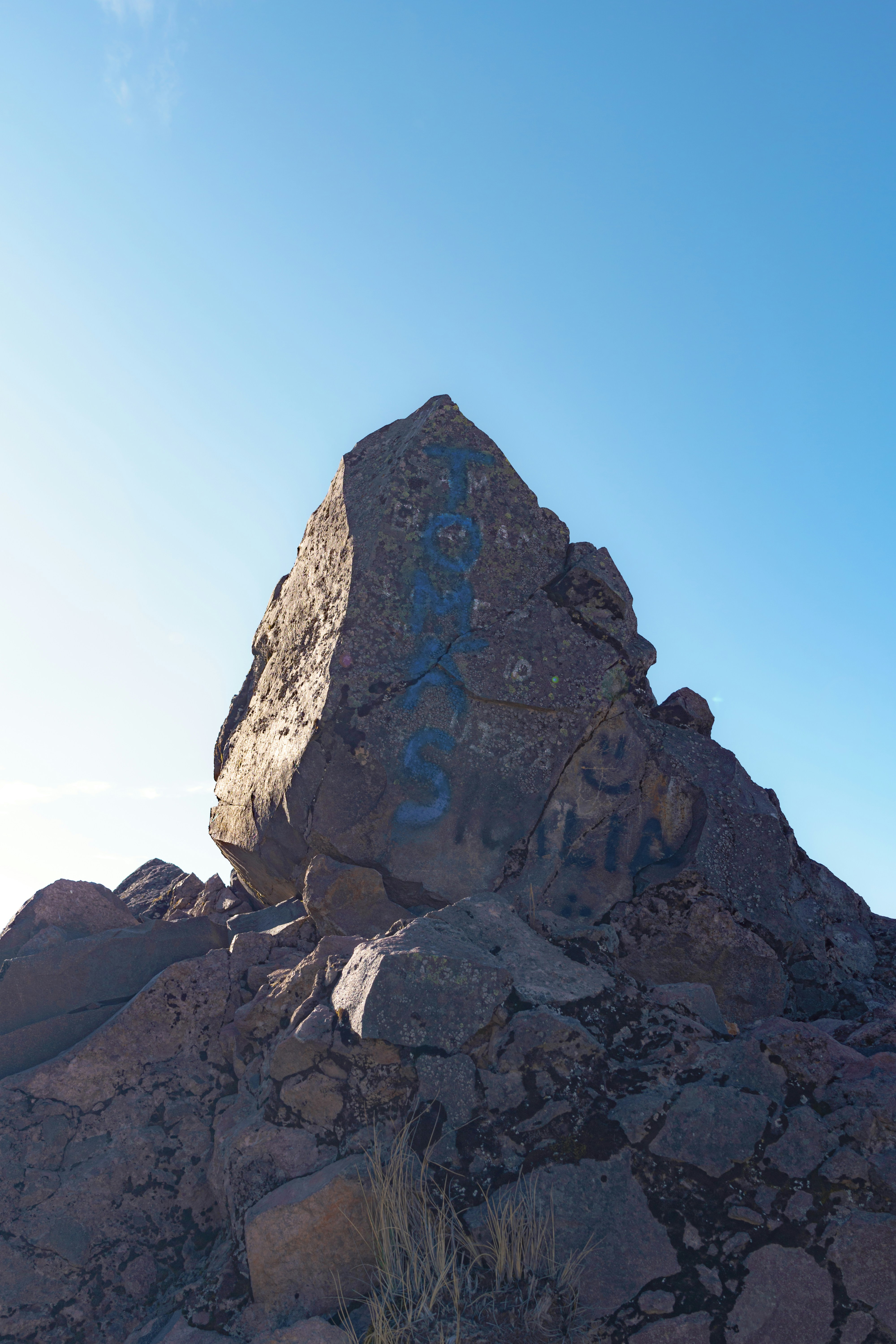 a large rock with graffiti written on it