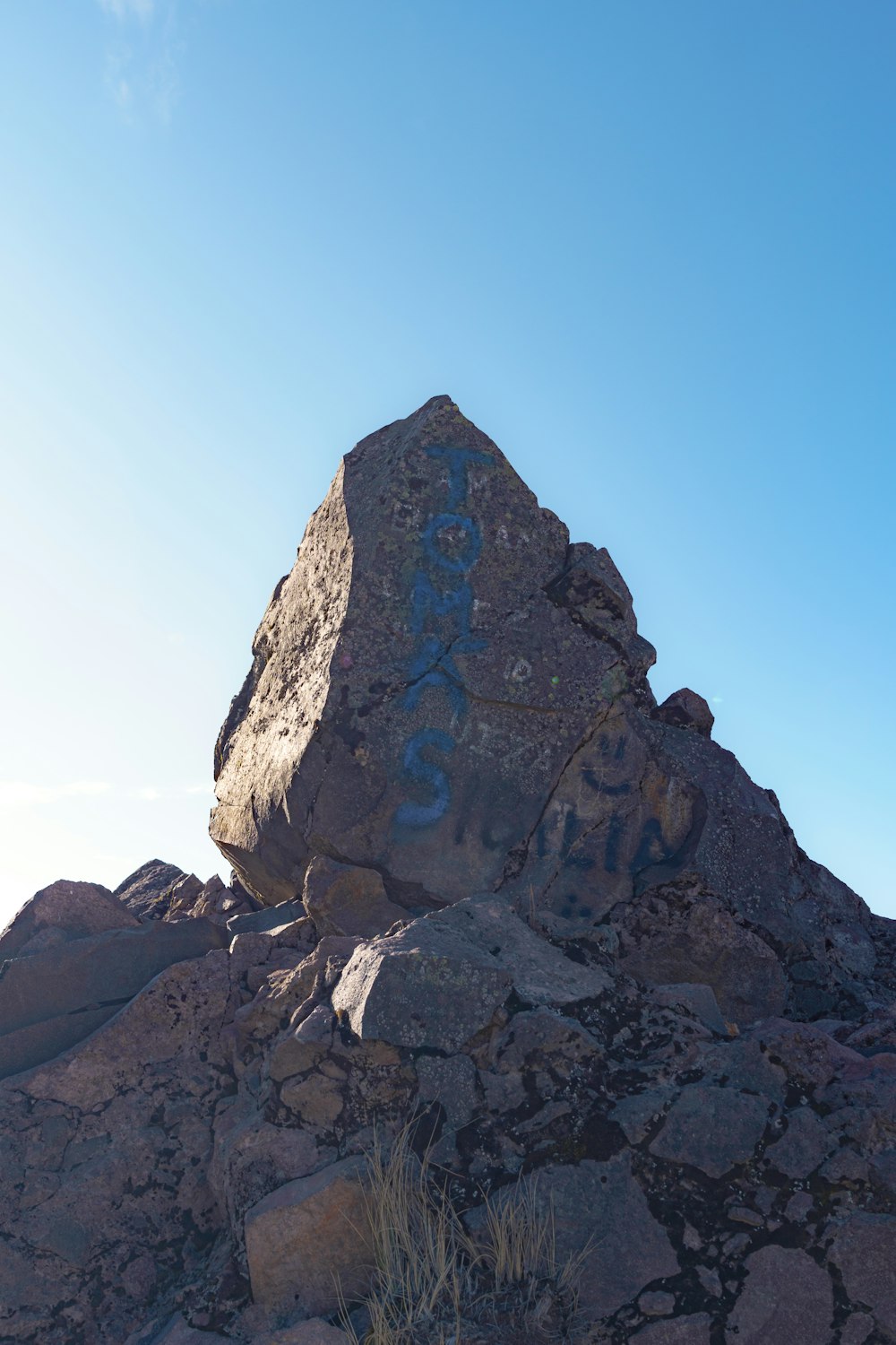 a large rock with graffiti written on it