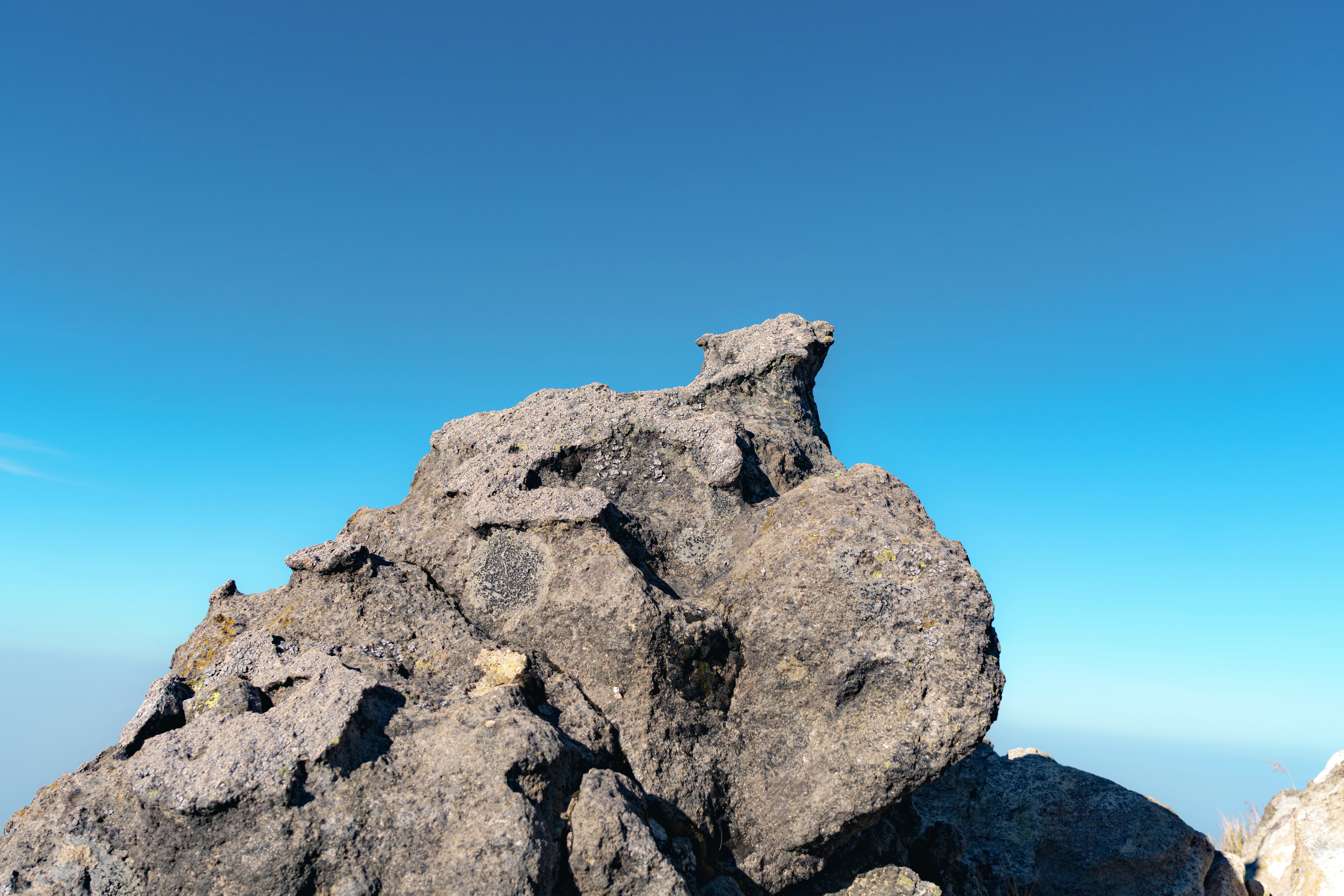 A rock formation with a blue sky in the background photo – Free Forest ...