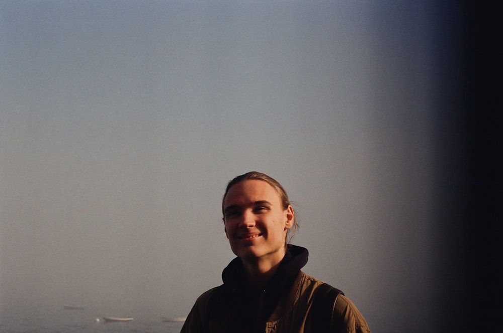 a man standing in front of a body of water