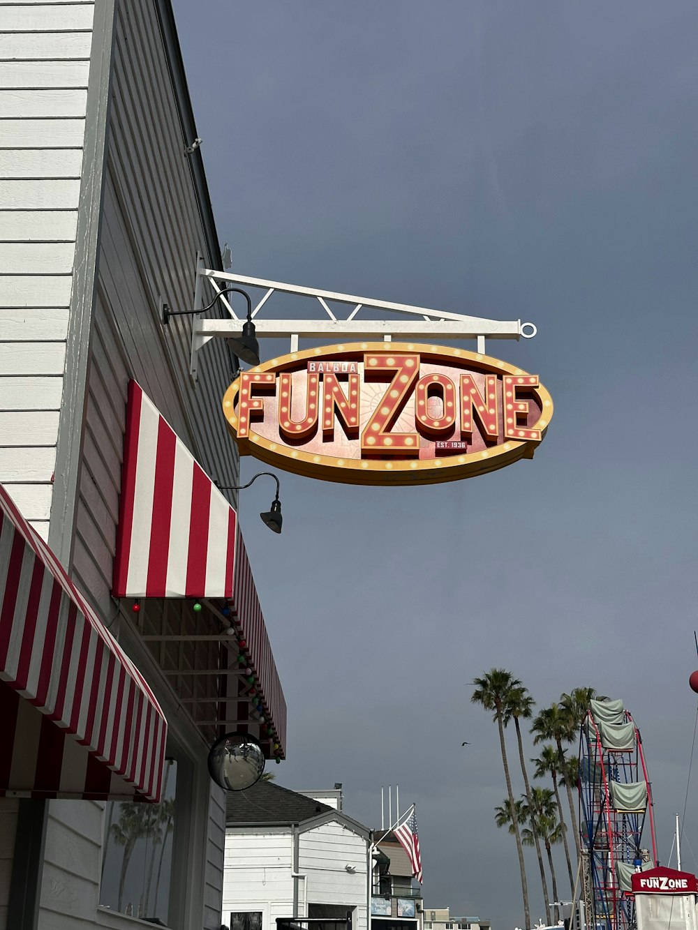 a neon sign hanging from the side of a building