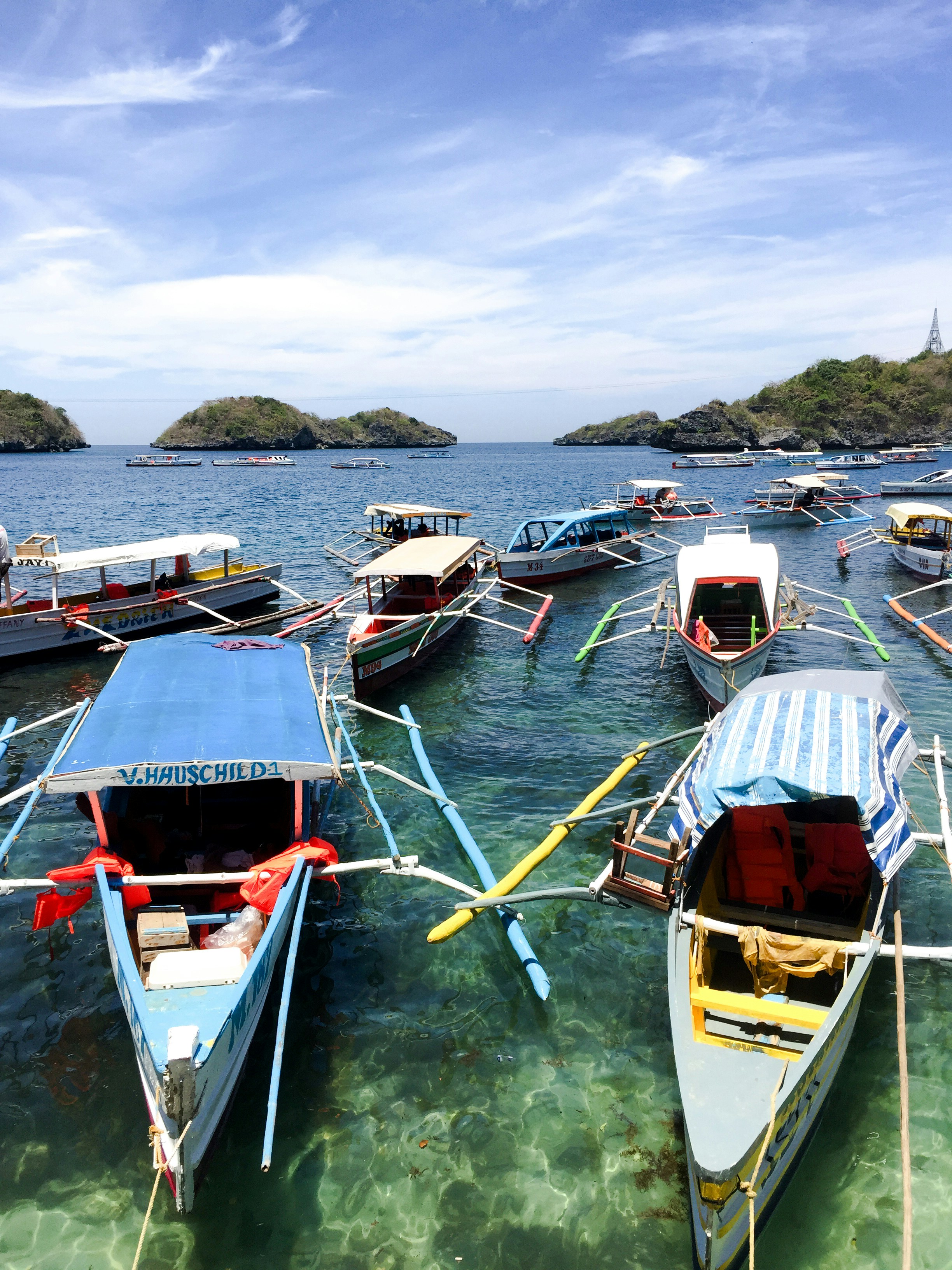 Samal Island crystal clear turquoise waters with outrigger boats