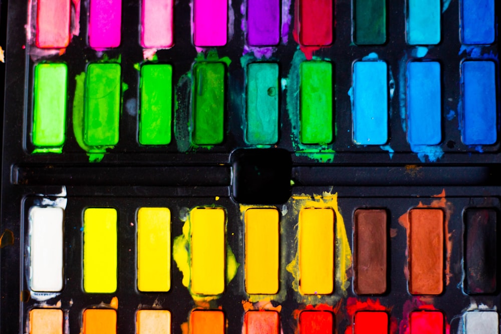 a close up of a palette of colored paint