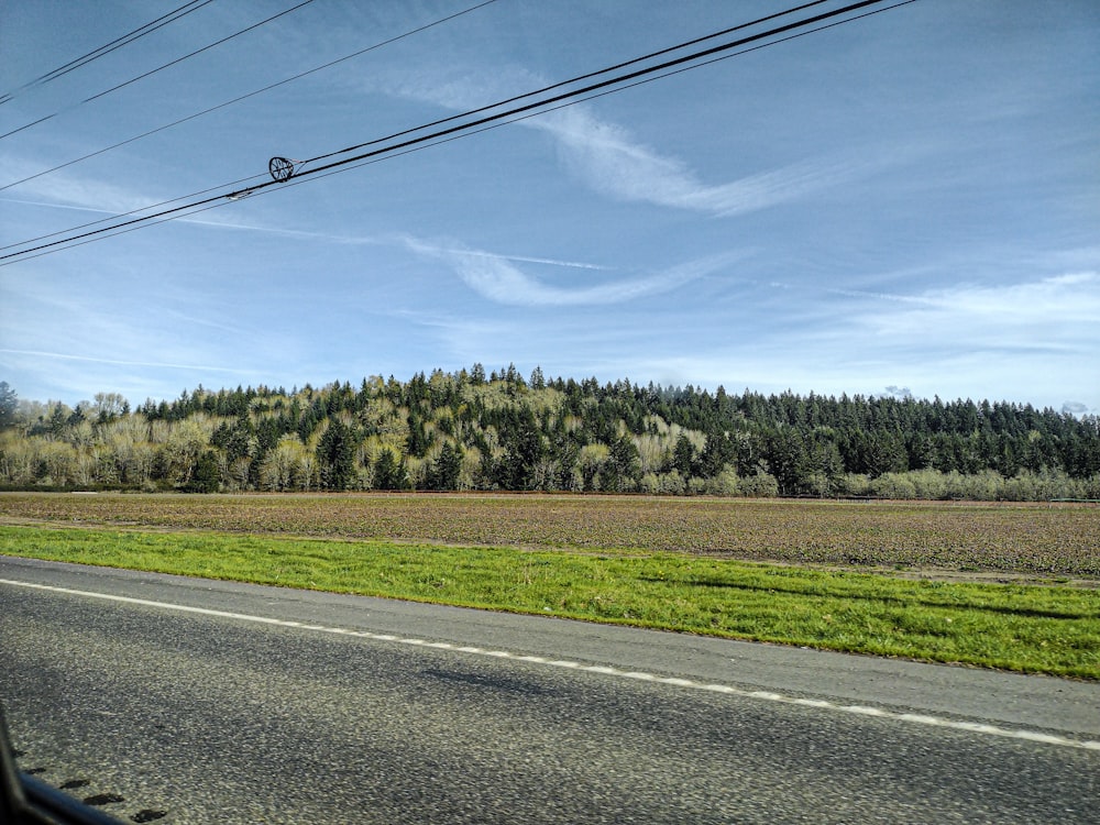 a view of a field from a car window