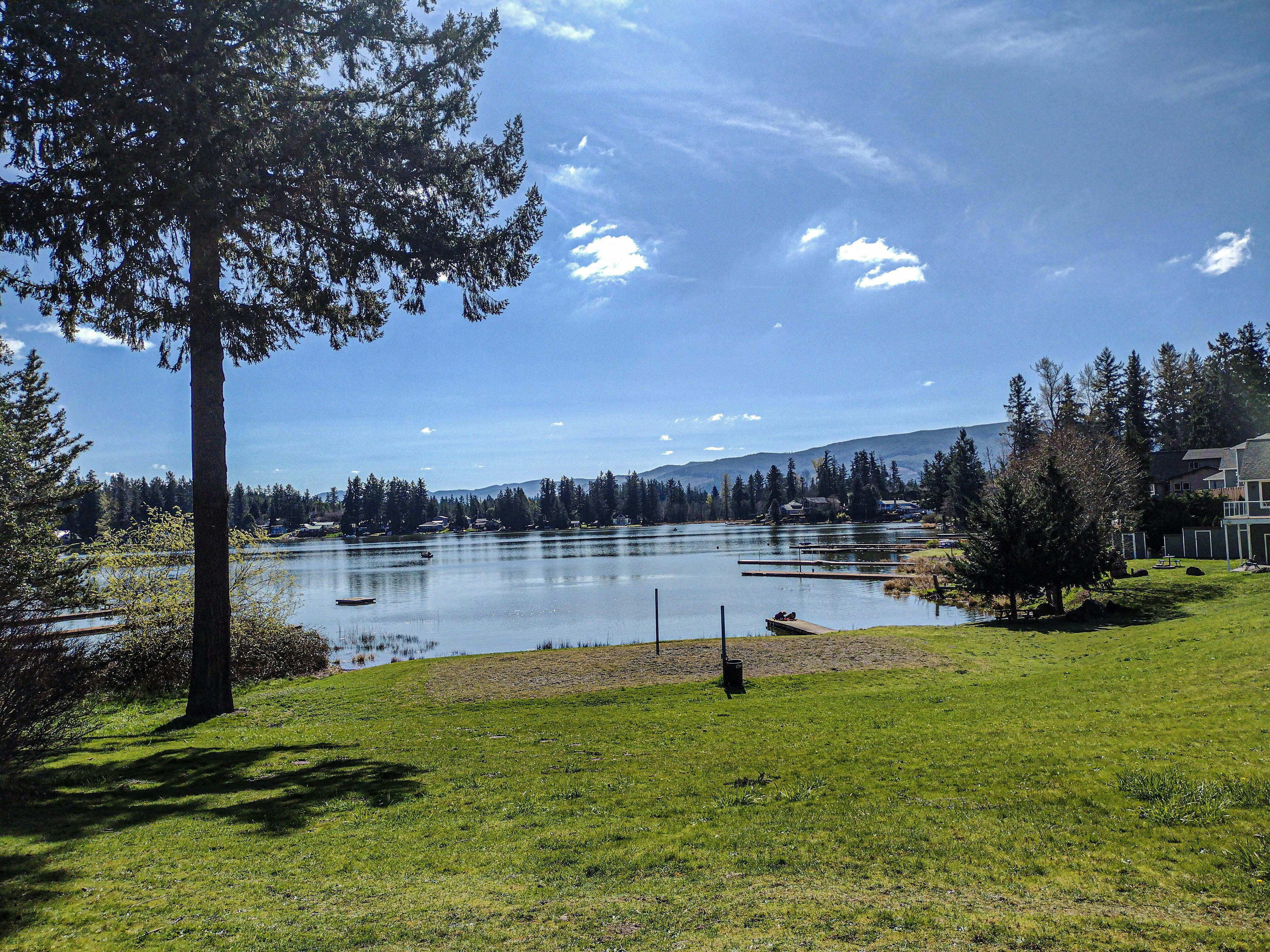 a lake surrounded by trees and a house