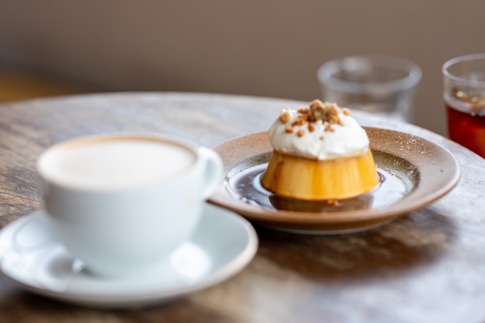 a cup of coffee and a pastry on a table