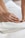 a close up of a person laying in a bed with a towel