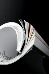 a close up of an open book on a table