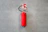 a red fire extinguisher hanging on a wall