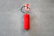 a red fire extinguisher hanging on a wall
