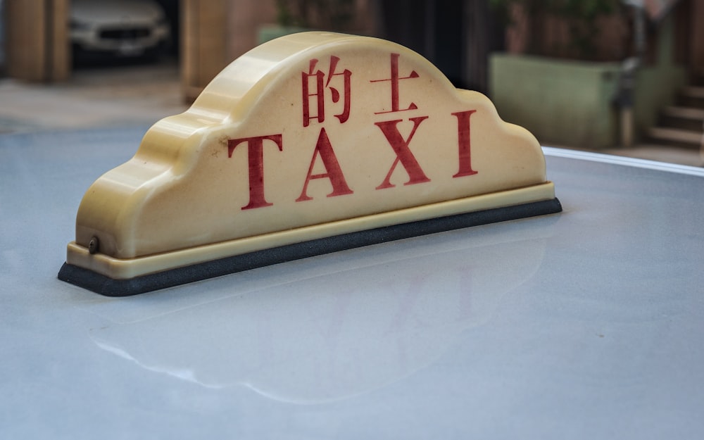 a taxi sign sitting on top of a car