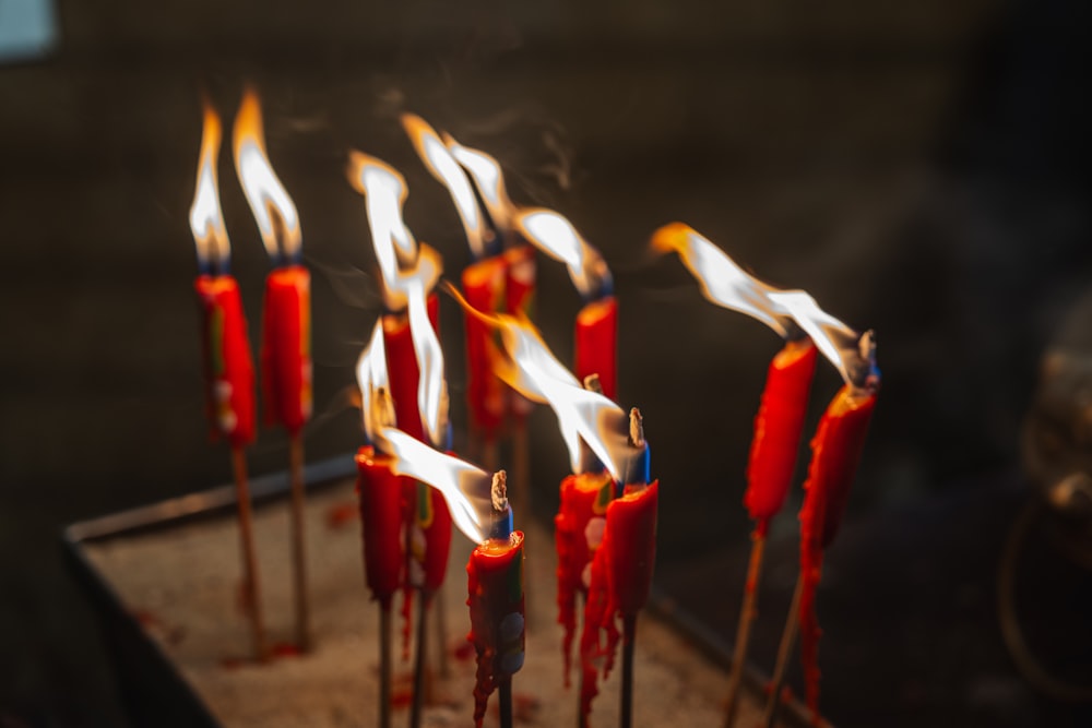 a bunch of red candles that are on a table