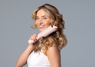 a woman holding a hair dryer in her hand