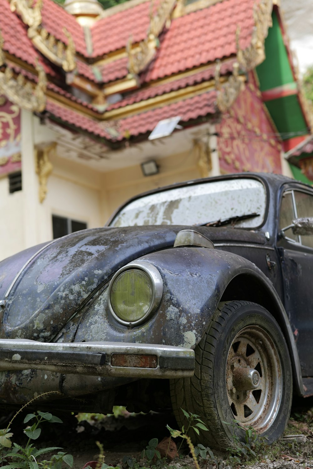 an old car sitting in front of a building