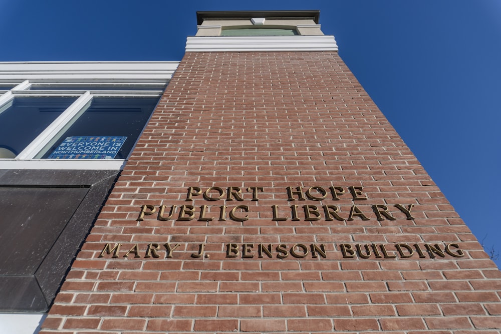 a tall brick building with a sign on it