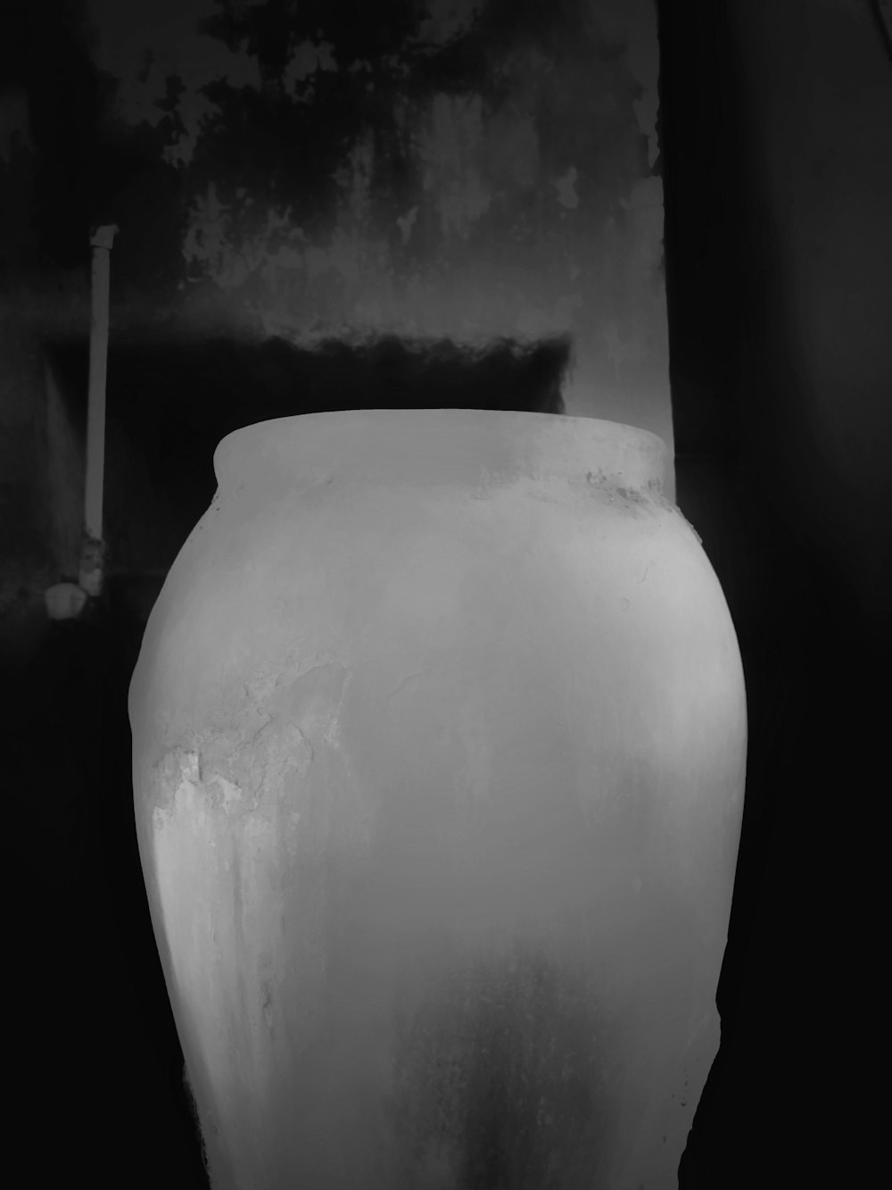 a white vase sitting on top of a table