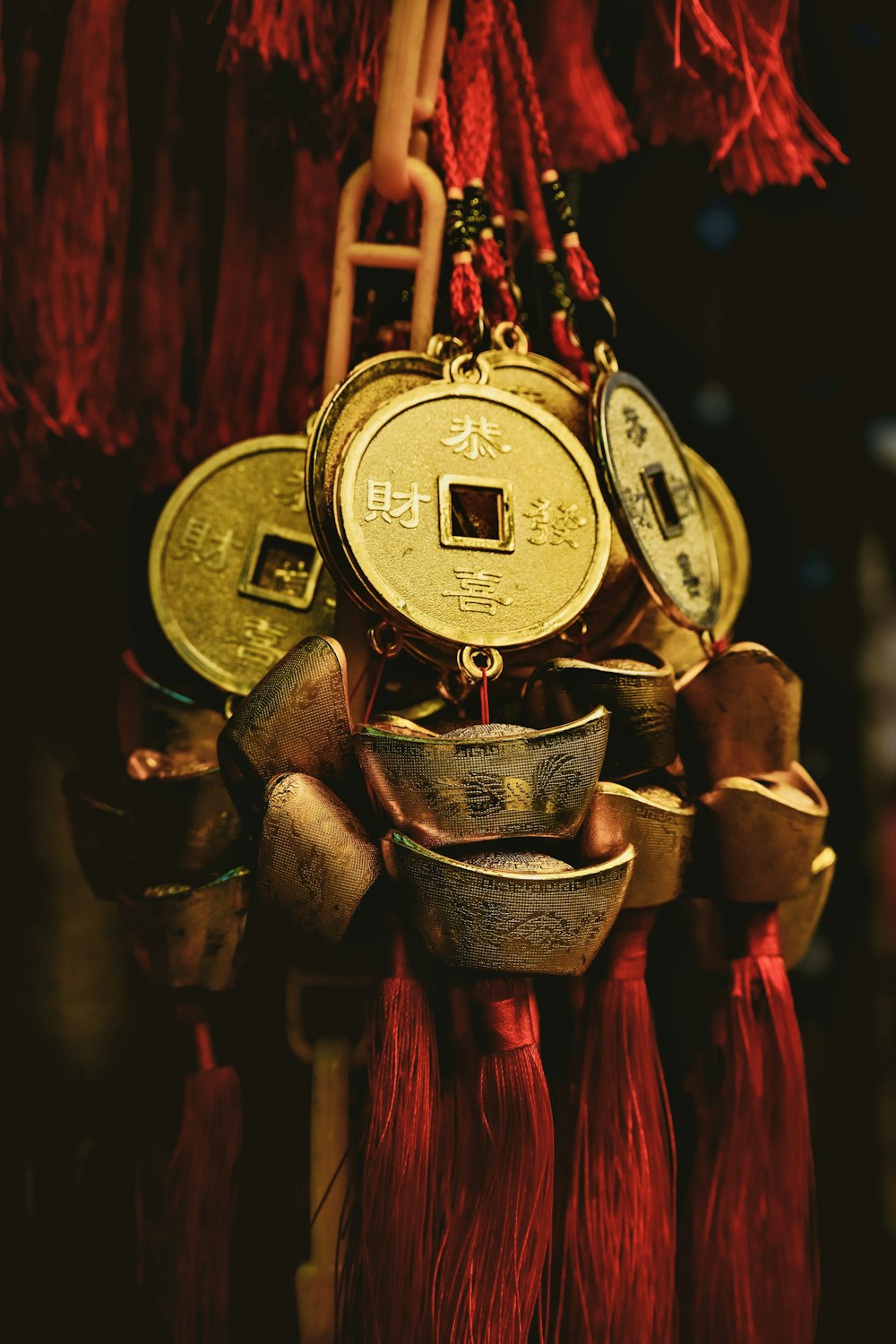 a close up of a clock with tassels hanging from it