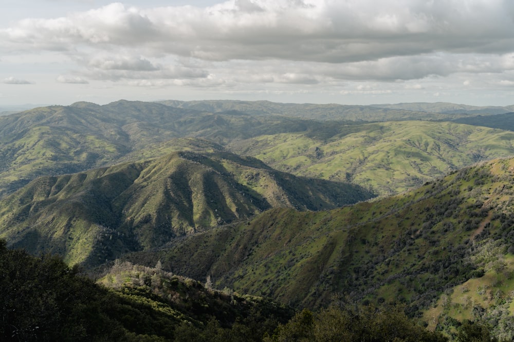 a view of a mountain range with a cloudy sky