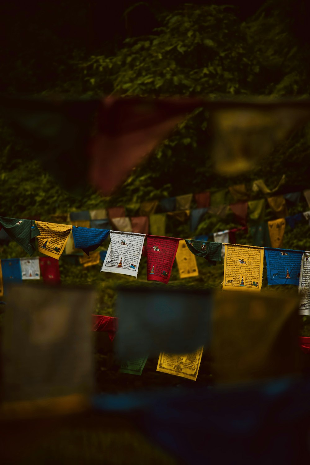 a bunch of colorful flags hanging from a line