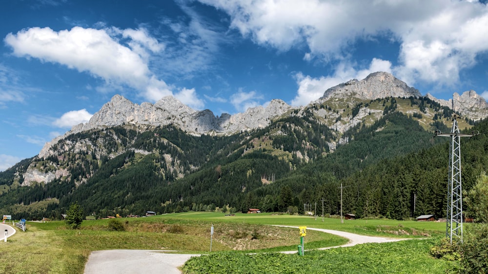 a scenic view of a mountain range with a road in the foreground