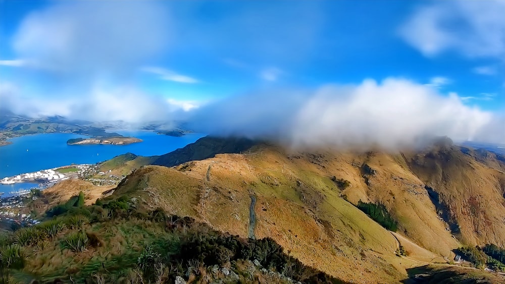 a scenic view of a mountain with a lake in the distance