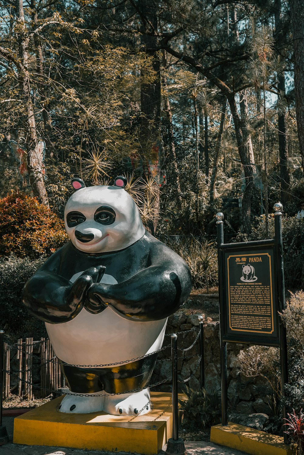 a large statue of a panda bear in a park