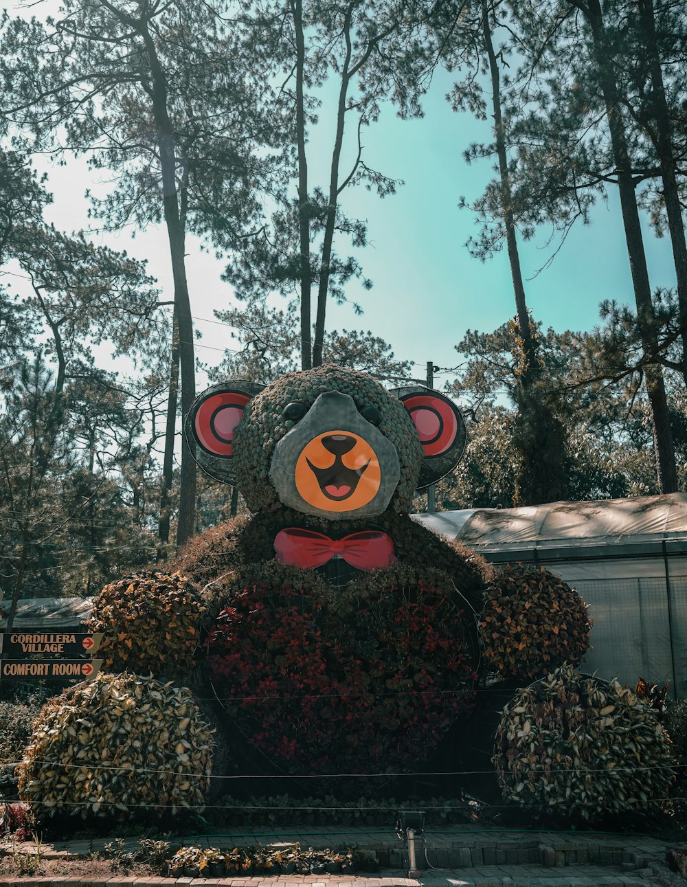 a large teddy bear made out of flowers