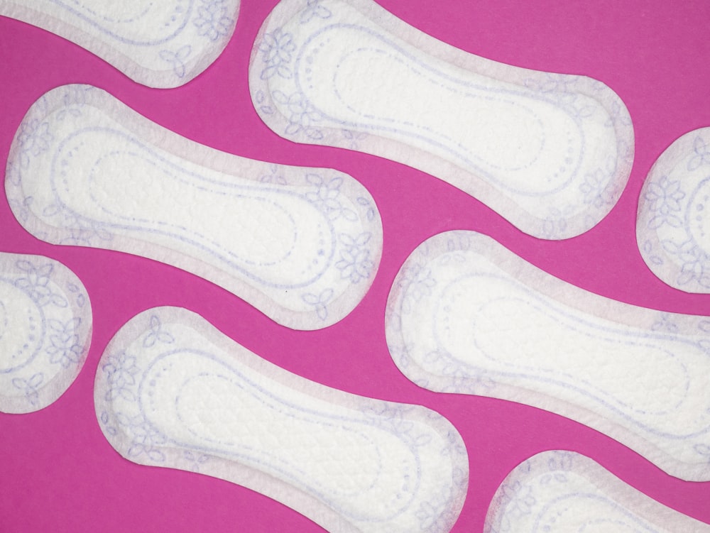 a close up of a pair of white shoes on a pink background