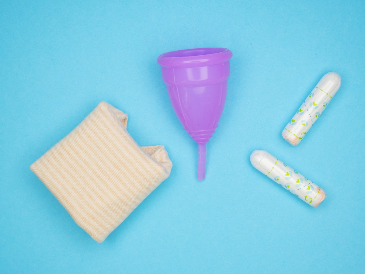 a purple plastic cup next to a small purple cup
