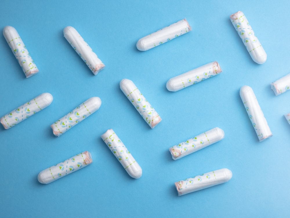 a group of pills sitting on top of a blue surface