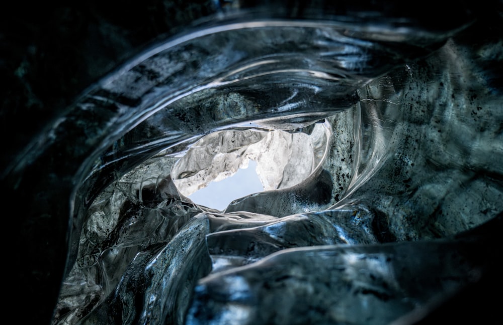 a view of a mountain through a tunnel of ice