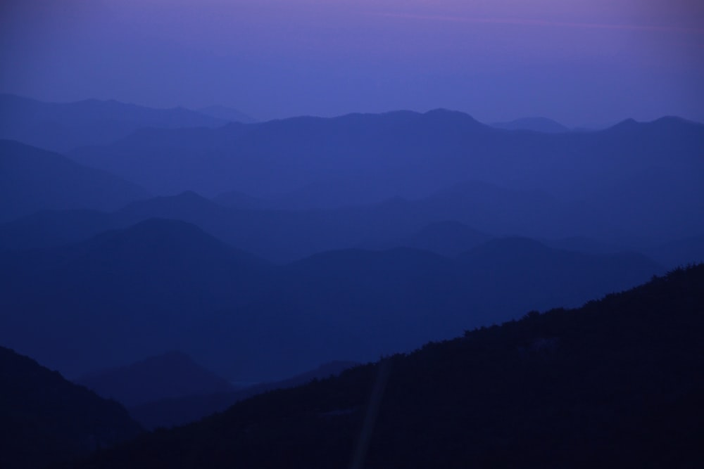 a view of a mountain range at dusk