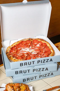 a pizza sitting in a box on top of a table
