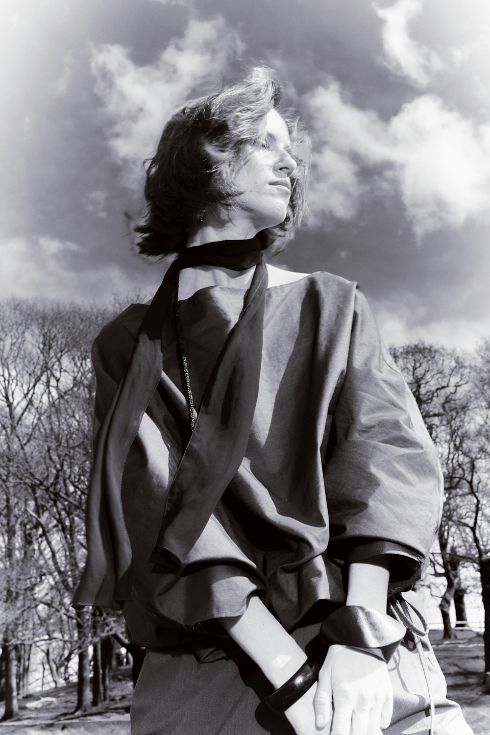 a black and white photo of a woman wearing a tie